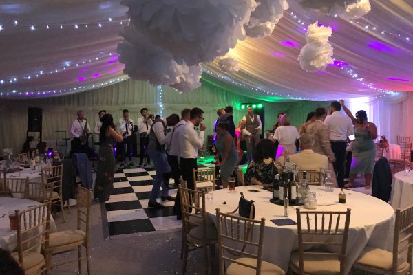 guests dancing in the evening in the marquee